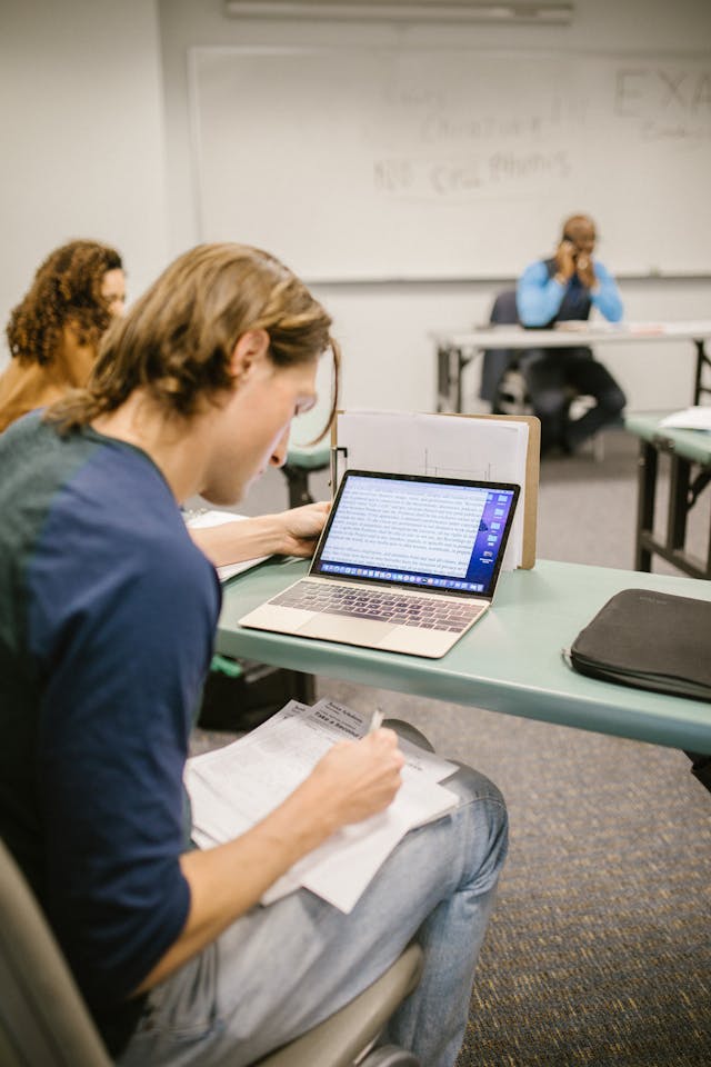 Student using laptop in classroom